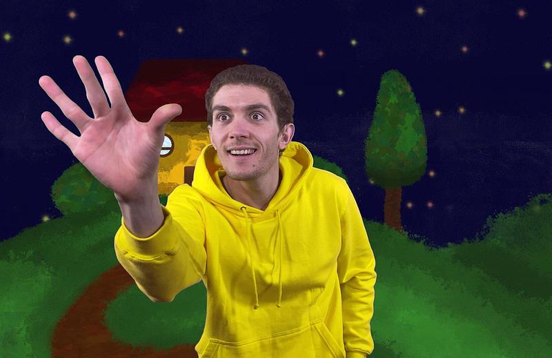 Mac wearing yellow jumper, surrounded by house, garden and a starry sky
